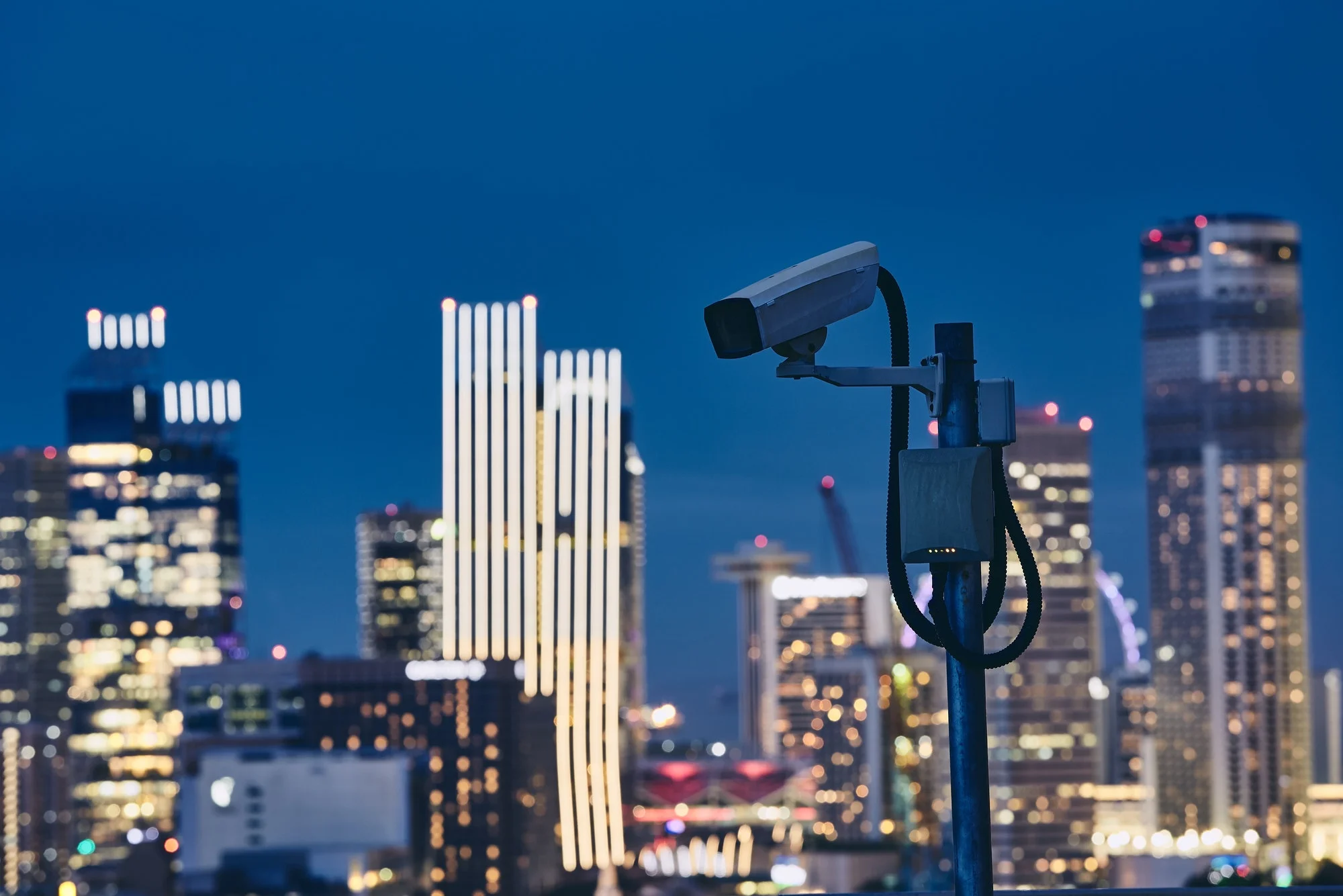 security-camera-against-illuminated-urban-skyline-at-night-concept-of-surveillance-and-safety-